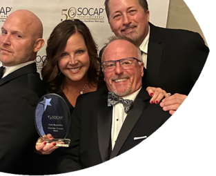 Alta Resources' Amy Bouthlilet, Patrick Nicholson, Mark Strassburg, and Steve Seidl celebrate Amy receiving the 2023 SOCAP Impact Supreme Trainer Award